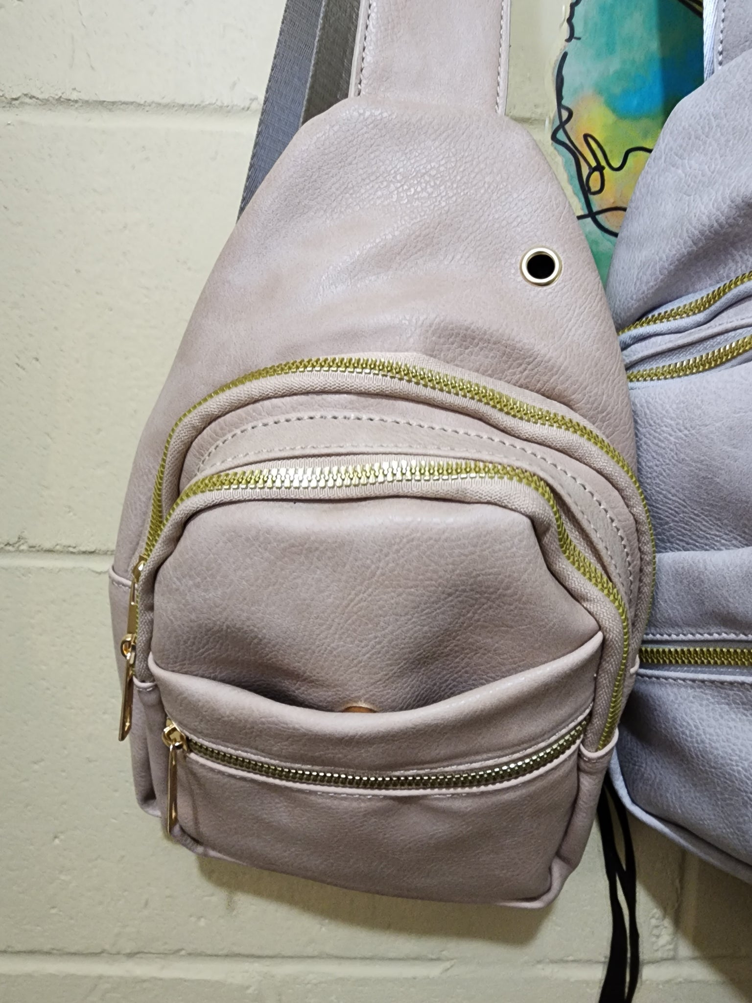 Sling bags with multi zippered pockets